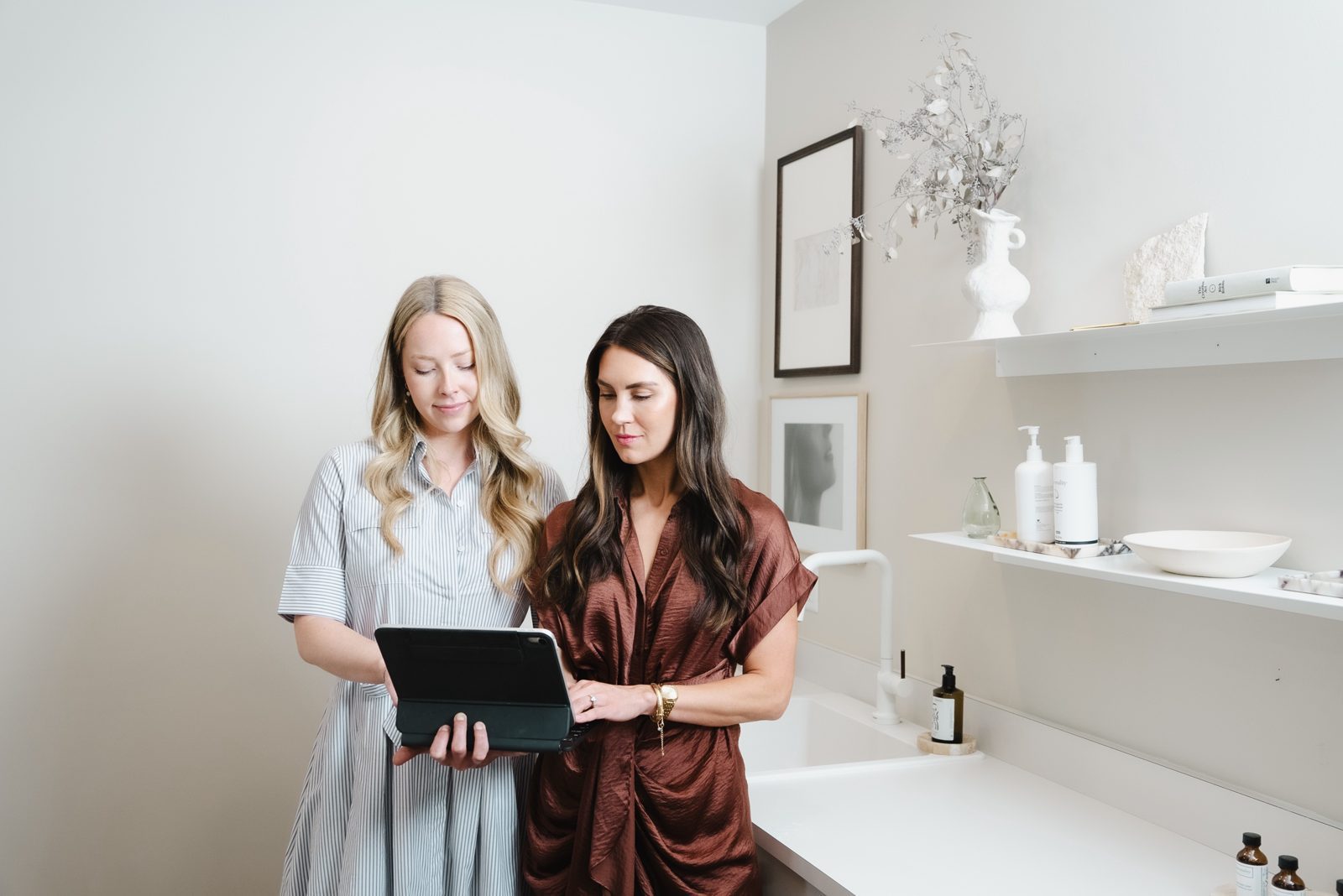 Two Be Your Kind providers reviewing a treatment plan on a tablet