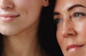 Two women close together, soft natural light, glowing healthy skin